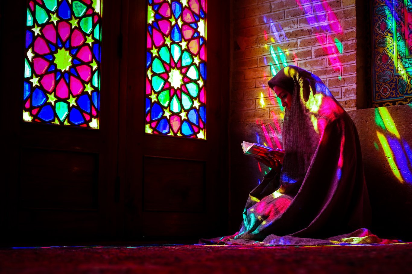 I en av moskéerna i Shiraz, Iran, sitter den här kvinnan under fönstret och läser Koranen.